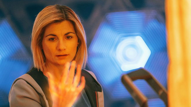 Jodie Whittaker's Doctor holding out her glowing hand as she starts regenerating