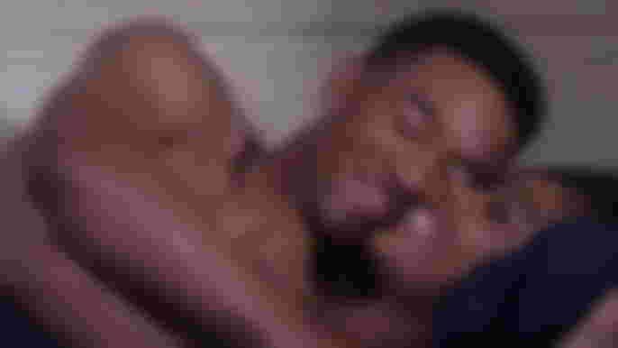 All American: Homecoming Season 1 Peyton Alex Smith as Damon hugging Geffri Maya as Simone in bed