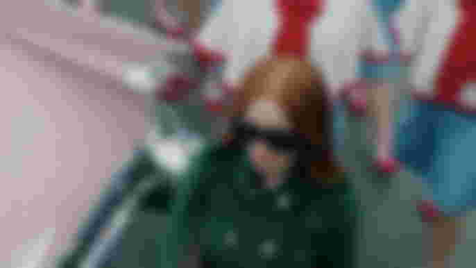 Riverdale Season 6 Madelaine Petsch as Cheryl Blossom walking wearng green coat