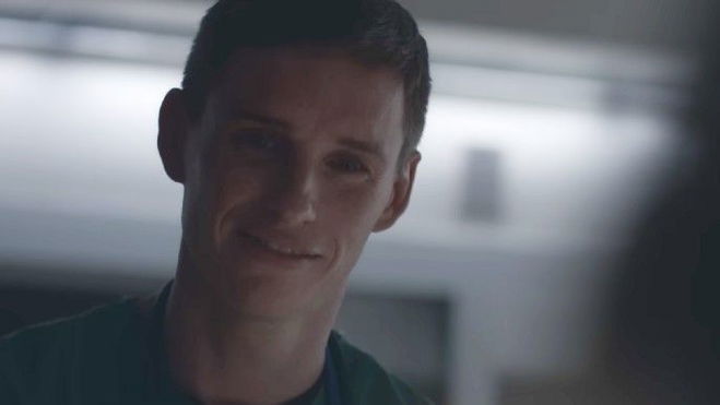 Eddie Redmayne as Charlie Cullen in The Good Nurse smiling creepily