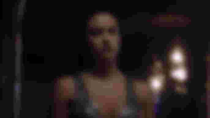 Riverdale Season 6 Camila Mendes as Veronica Lodge looking at mirror wearing silver gown