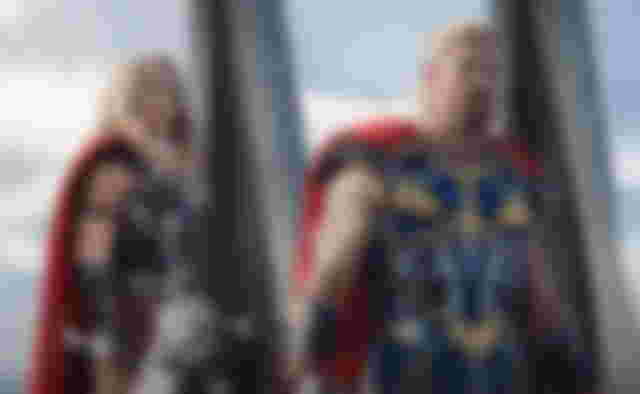 thor love and thunder natalie portman (as jane foster) and chris hemsworth (as thor) wearing their superhero uniforms