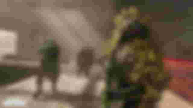 Screenshot showing Warzone player wearing a ghillie suit and holding the ISO 45 SMG