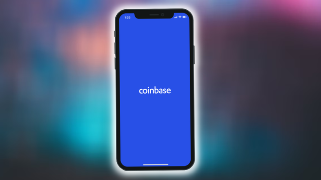 Image of the Coinbase Logo on a blue background on a phone, against a blurred blue/orange background.