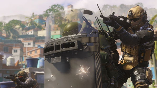 Modern Warfare 3 player firing gun with player holding riot shield in foreground