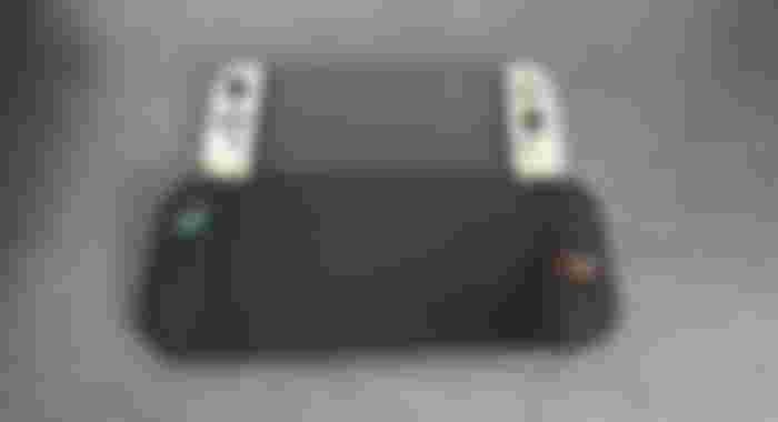 A black Switch 2 below a white and black OLED Switch.