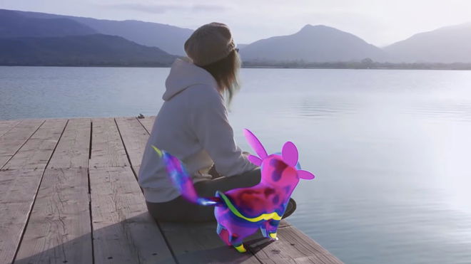 Image of a Peridot and their owner sitting on a pier.