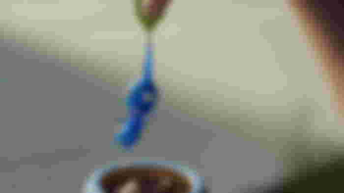 A blue Pikmin is pulled out of the dirt b his leaf in Pikmin Bloom.