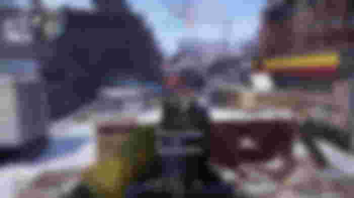 A first-person screenshot of XDefiant gameplay showing the M16 build in action, with the player firing at an enemy down a snowy street.