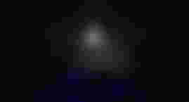 A player holds the Haunted Mirror in the basement of a house in Phasmophobia.