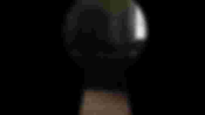 Looking through the keyhole of a door in Shinra Mansion.