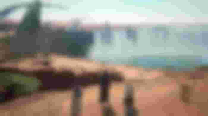 Multiple characters are next to the waterfall in Final Fantasy 16.