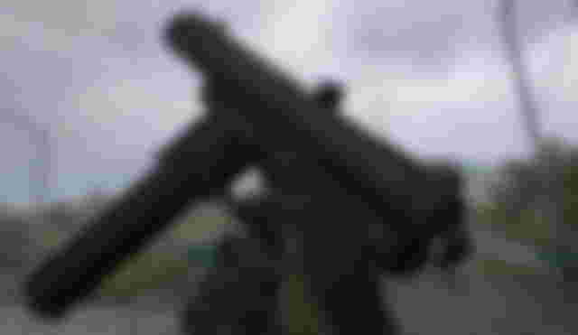 Screenshot of Warzone 2 player holding FTAC Siege pistol with grey skies in background