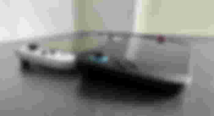 A black Switch 2 depth comparison to a white and black OLED Switch.