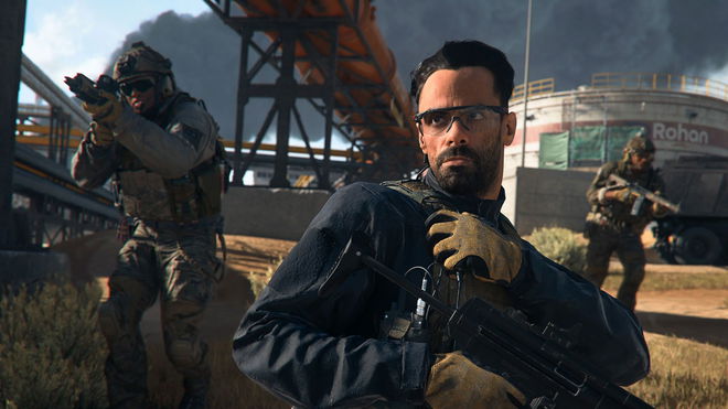 Screenshot of Modern Warfare 2 player holding vest and a submachine gun with nearby soldiers in the background