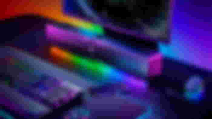 Best soundbar for gaming - Razer Leviathon V2 Pro product image of a black soundbar surrounded by RGB lighting sat at a desk with a monitor, keyboard, and mouse.