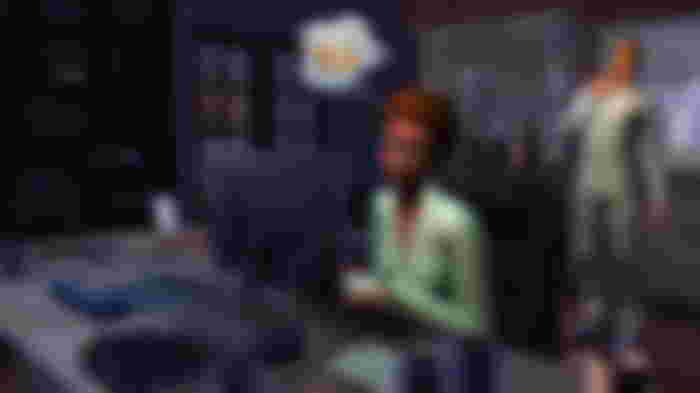 A lady is working on the computer in Sims 4.