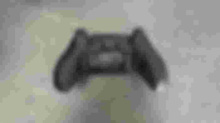 The back of a black SCUF PS5 controller, featuring mappable back paddles.