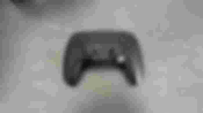 The front of a black SCUF PS5 controller.