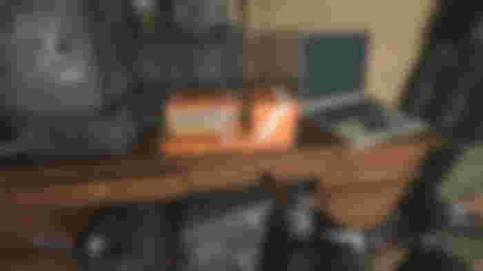 Modern Warfare 3 flight recorder on wooden desk next to laptop