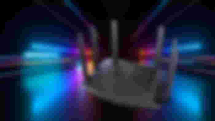 A black Acer Wi-Fi router with six antenna and different color streaks of light behind it.