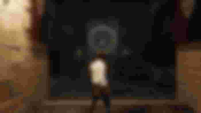 Pinocchio standing in front of an Ergo propaganda poster.