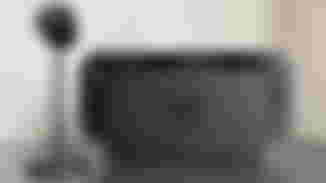 The Nintendo Switch 2 in black docked with the black camera accessory next to it.