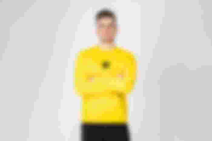 Lachlan standing in front of a blank background.