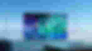 Image of a flatscreen OLED TV with crystals on the display, and the TV in front of a blue background.