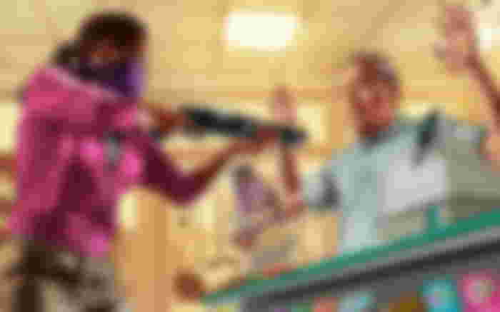 Image of a character robbing a store in GTA 5.