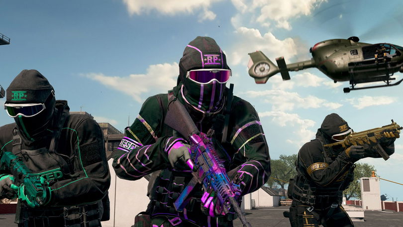 a group of soldiers are standing next to each other in a video game with a helicopter in the background .