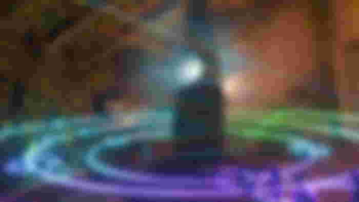 A magical stone shining with a bright light, with blue purple and green rings surrounding it, thanks to Crystals