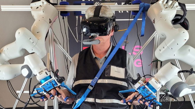 An XPRIZE 2022 judge reviewing the Doctor octopus style vr controlled robot 