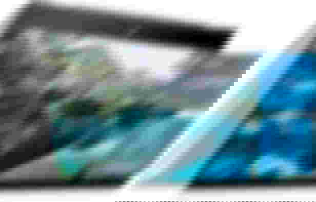 HP Pavilion X360 product image of a foldable white and black laptop with a mountain lake scene on the display.