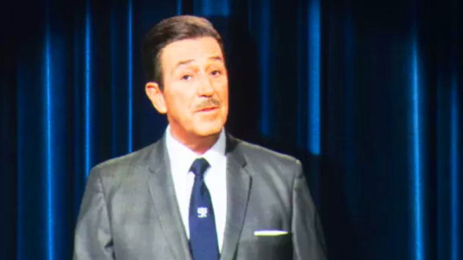 An image of AI Walt Disney walking and talking at the Disney 100: The Exhibition event in 2023 