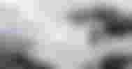 A white SSD with white branding on its layered front sat on top of internal PC components.
