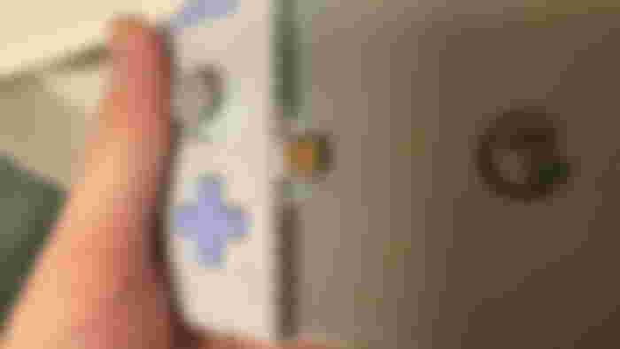 Close up of my hand holding the Gamesir X2s controller and pointed at the USB-C dongle