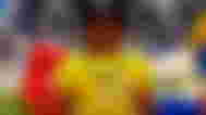 A roblox avatar in a yellow shirt with an IKEA name badge standing in front of an image of the IKEA store in Roblox.