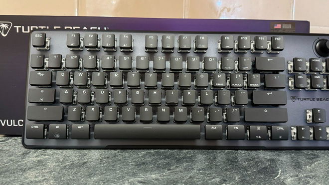 A Turtle Beach Vulcan II TKL Pro magnetic keyboard in front of its box and on a marble tabletop