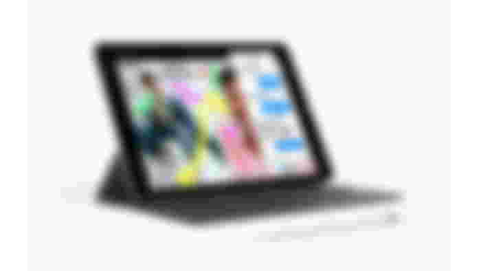 An iPad propped up by a collapsible keyboard.