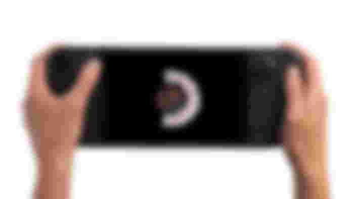 Steam Deck OLED product image of two hands controlling a black handheld console.