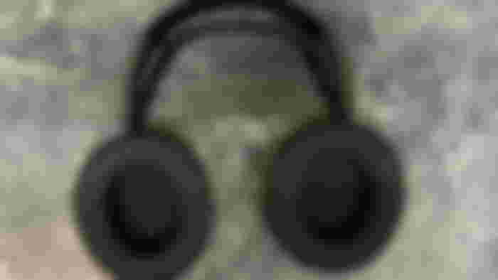 A pair of SteelSeries Arctis Nova 5 headphones laying down with the inside of the earcups on show