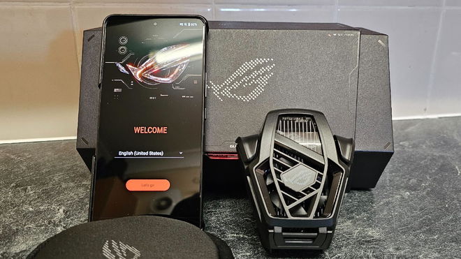 ASUS ROG Phone 8 Pro with Cooler next to it and the box behind it