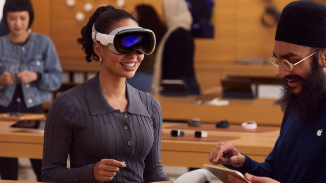 A woman wearing an Apple Vision Pro headset in an Apple Store while an employee talks her through the demo