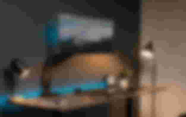 Vivo product image of a black monitor arm with an ultrawide monitor mounted with blue lighting beneath.