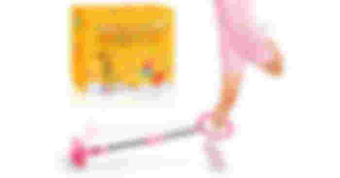 A child in a pink outfit swinging a pink ankle skipping rope around their leg.