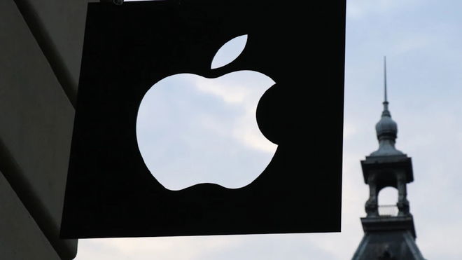 A black open apple logo in the middle of the sky 