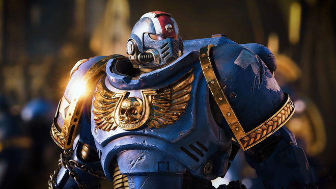 Warhammer 40k: Space Marine 2 - person in blue and gold armour, with a gold skull on their chest