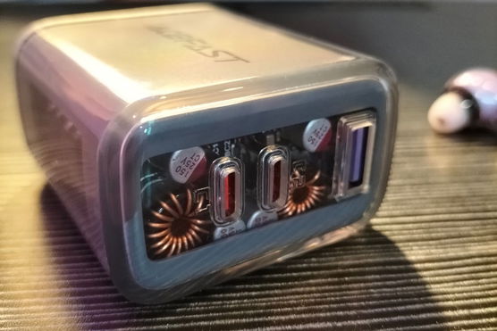 A grey multiport USB charger with a clear casing.