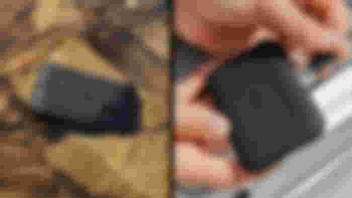 A black rubber external SSD being plugged in and shown in water.
